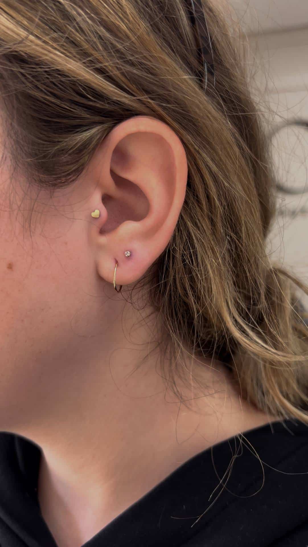 Flat and helix cartilage piercings built into a curated ear stack