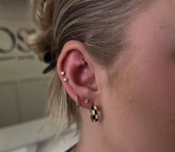 Curated ear with lobe and cartilage piercings done at Aurilus in American Fork, Utah
